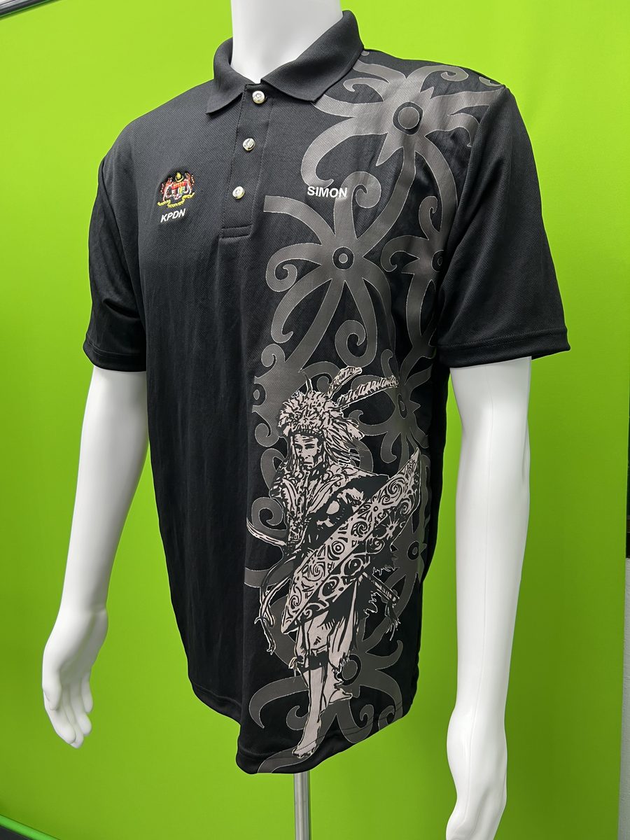 Black polo with embroidered crest and name, and a large tribal-pattern print down the front