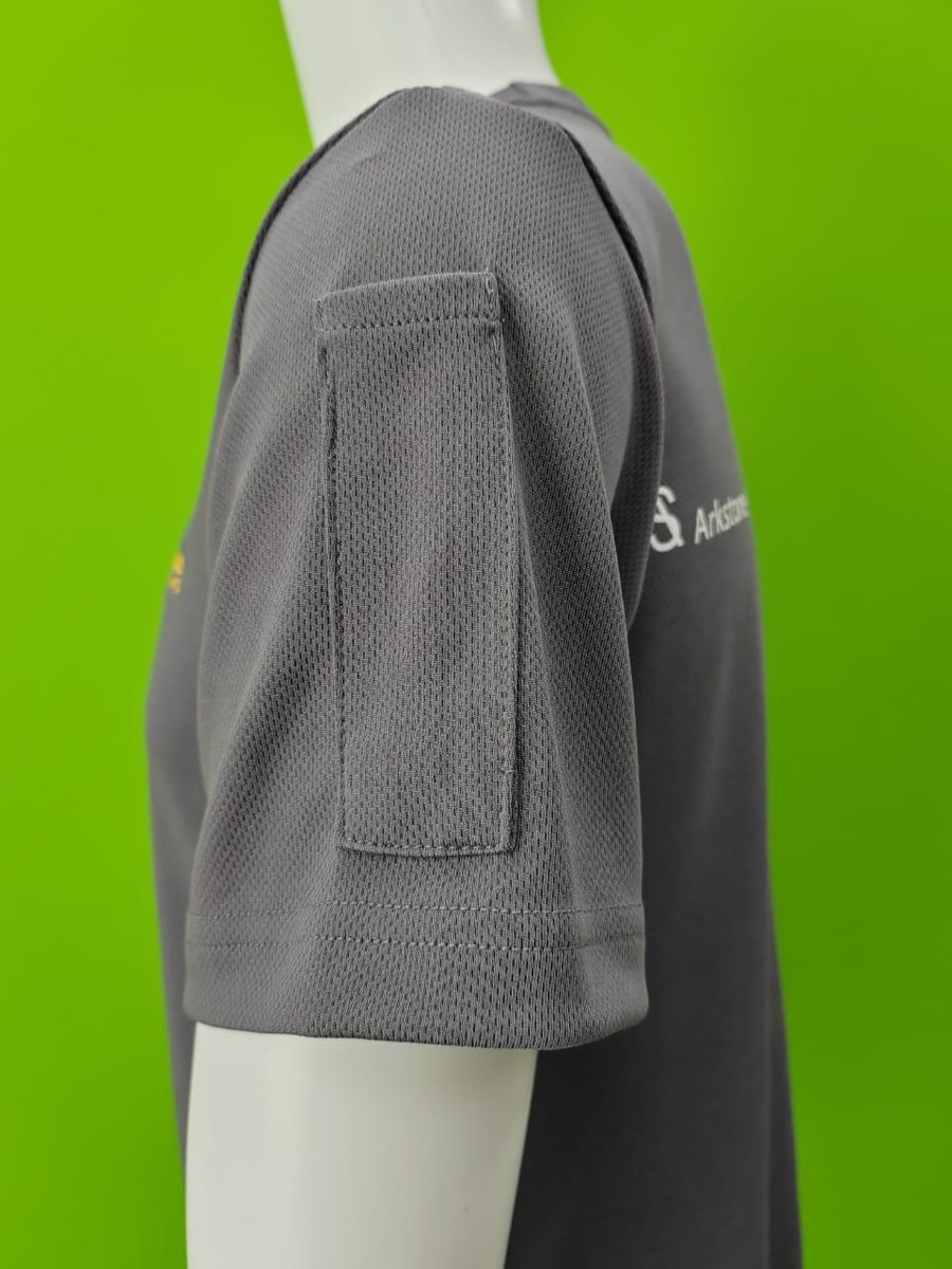 Close-up of a pointed pen pocket sewn onto the sleeve of a grey polo shirt